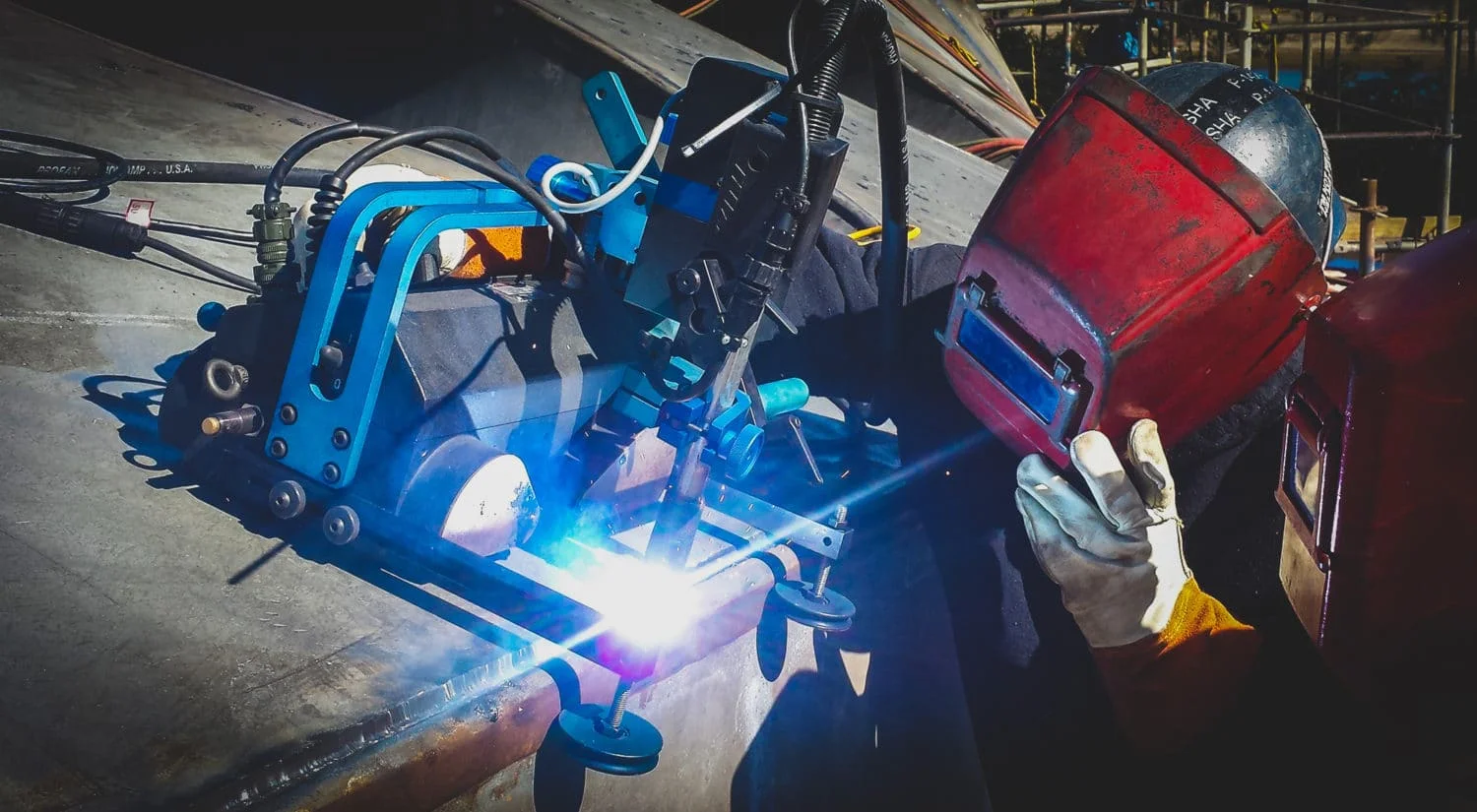 worker using automated welding machine