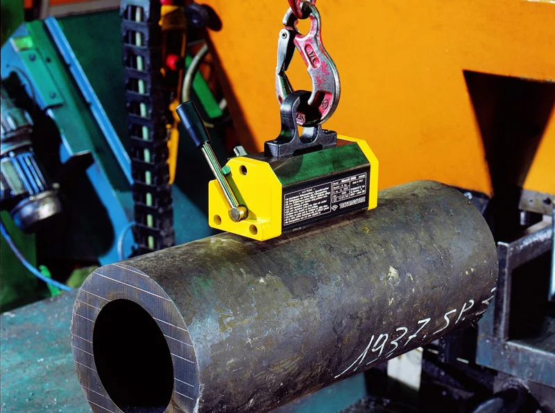 magnetic lifting clamp holding a steel pipe